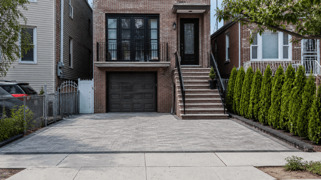 Paver driveway at a New York City row house, showing a clean two-car layout, proper edging, and the kind of finished installation homeowners compare when pricing driveway projects