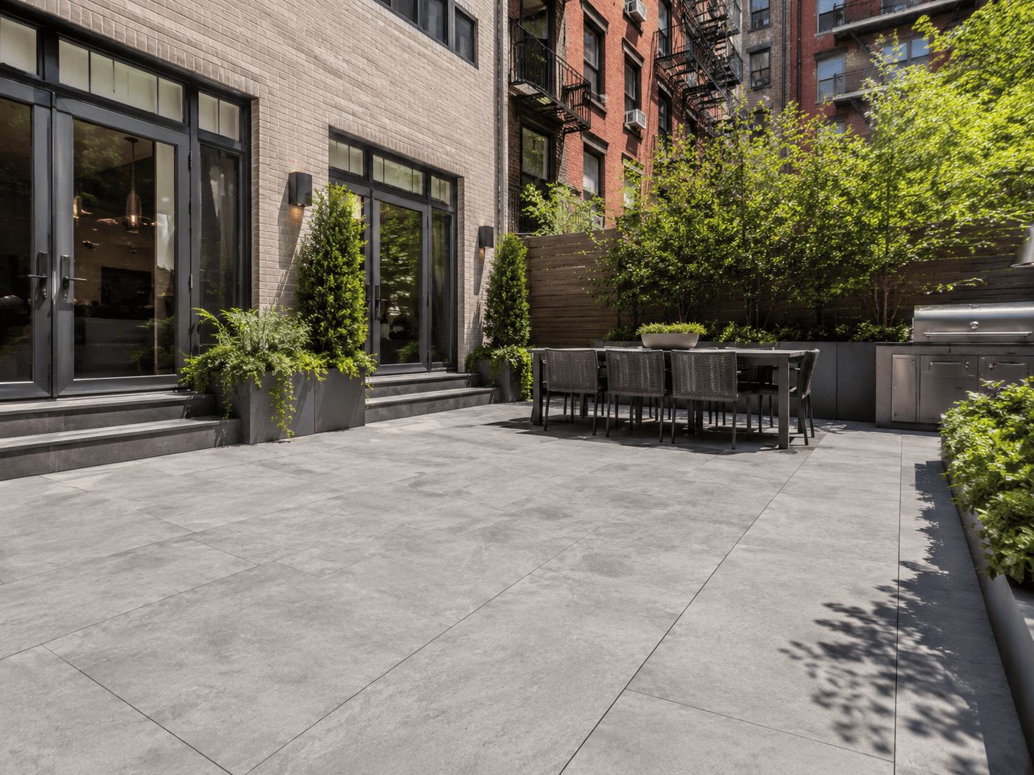 Large-format porcelain pavers installed in a modern residential courtyard