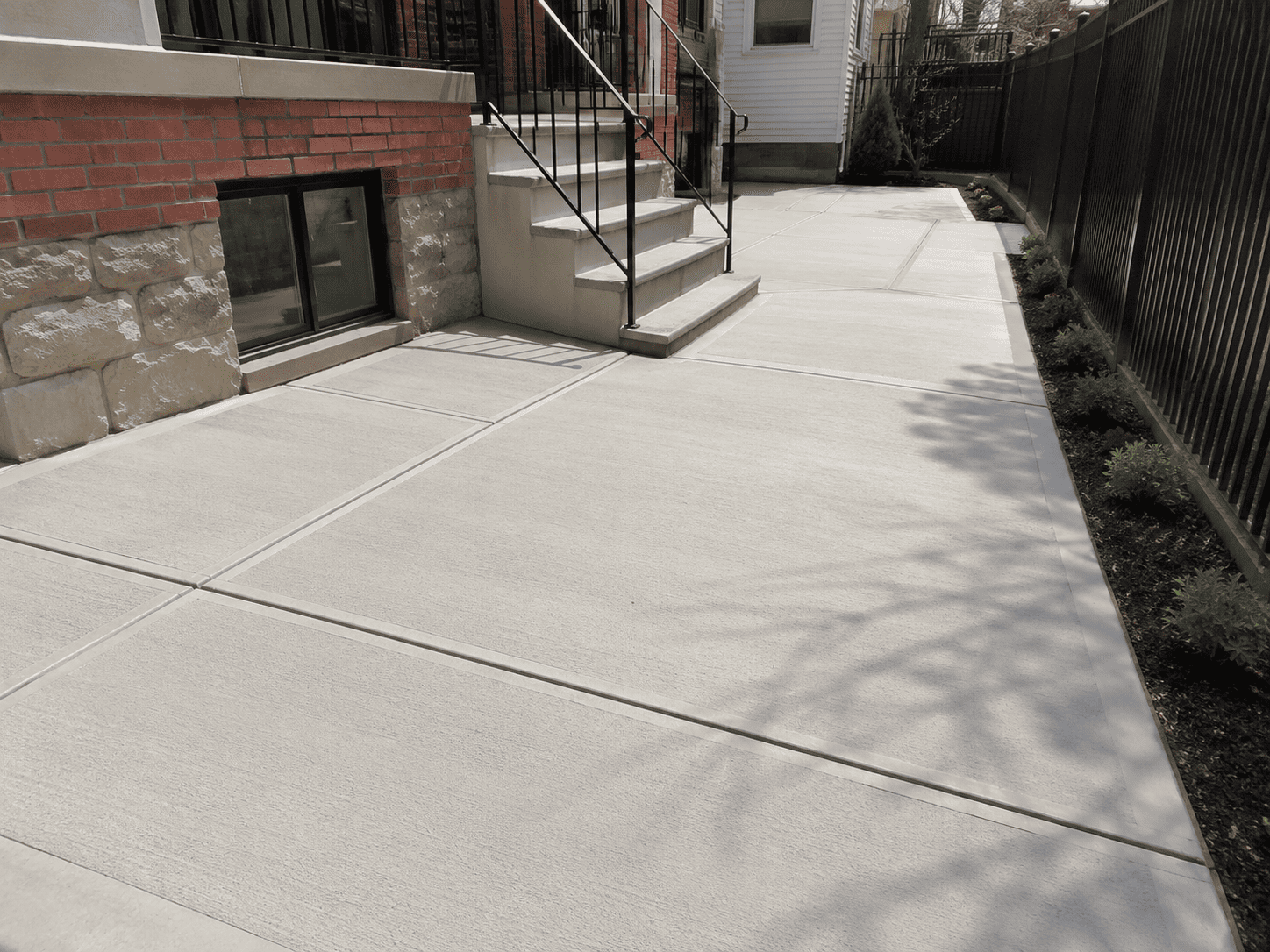 Completed concrete walkway beside a New York City townhouse