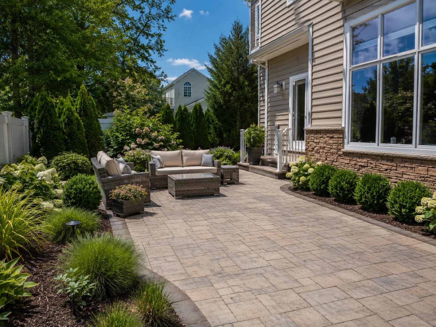 Paver patio and landscaped outdoor living area at a St. George Staten Island home