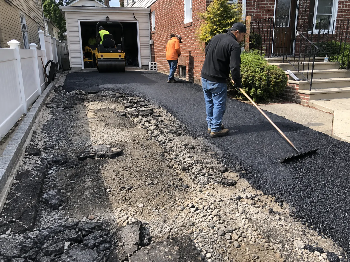 Old asphalt driveway being removed and replaced at a NYC property