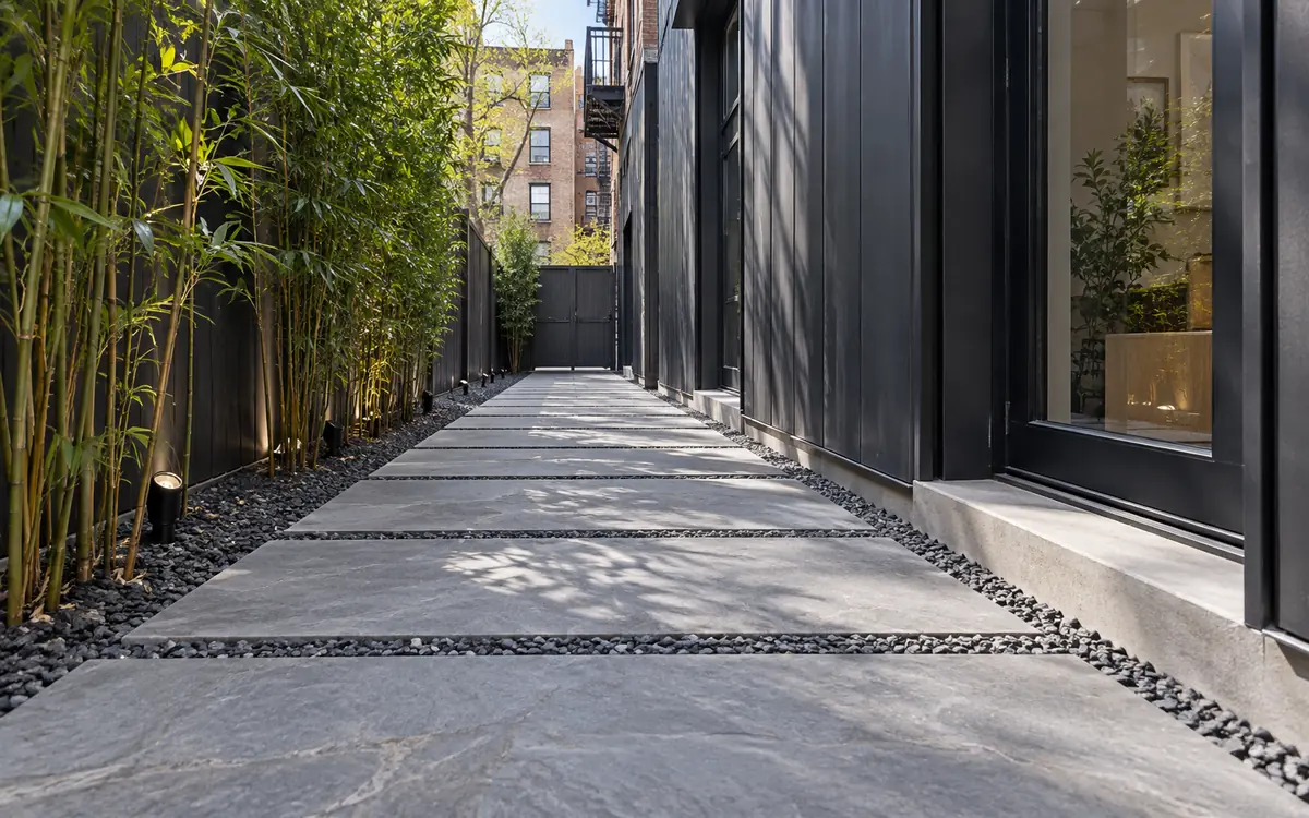 Linear bluestone walkway through a narrow urban side passage