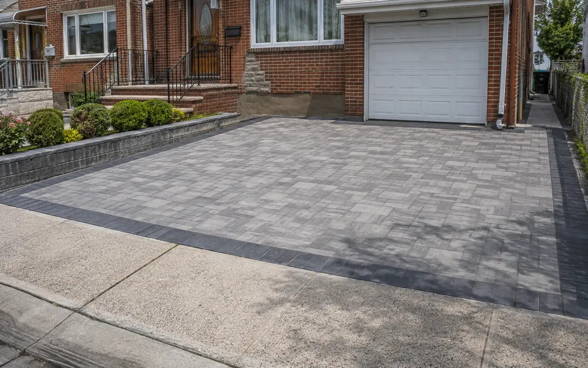 Finished interlocking concrete paver driveway at a Queens home
