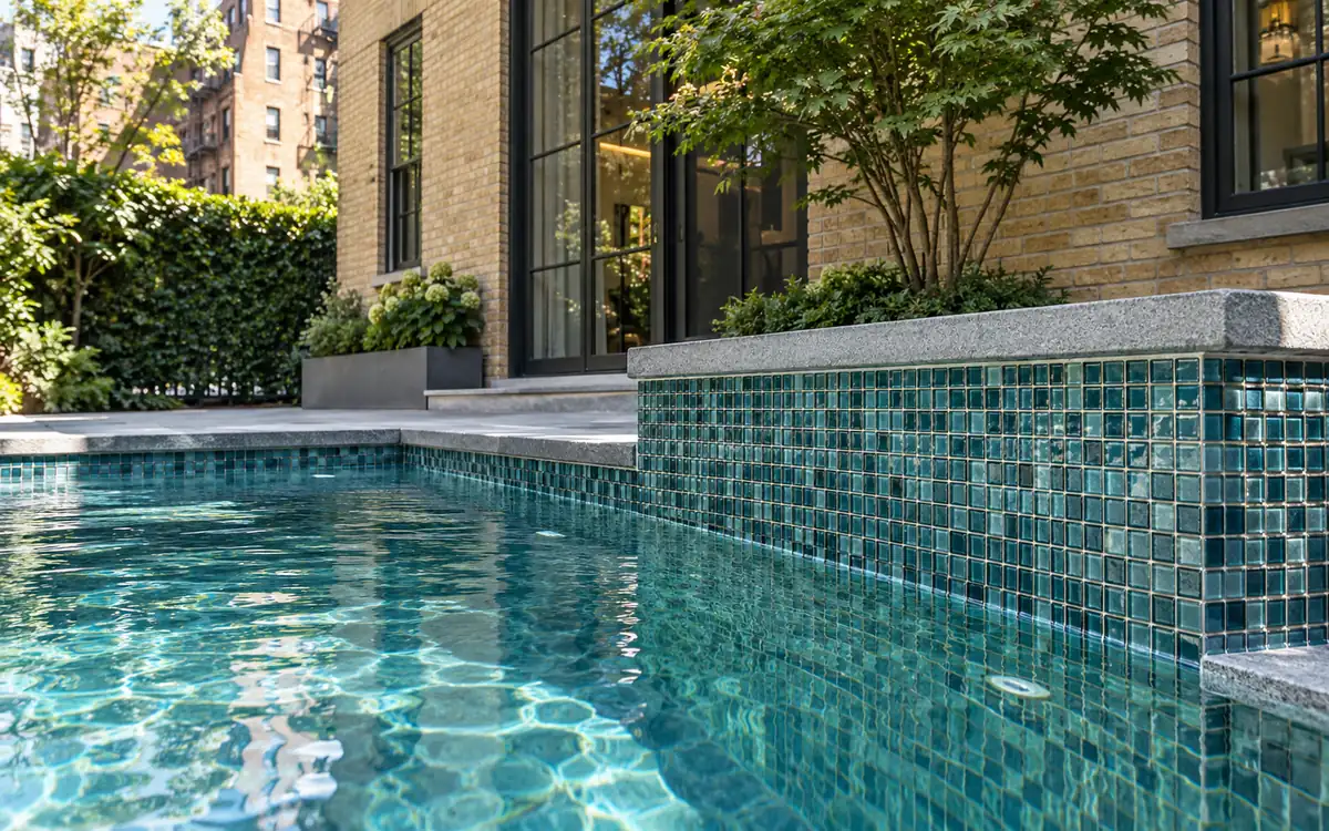 Blue-green decorative tile installed at a compact pool edge