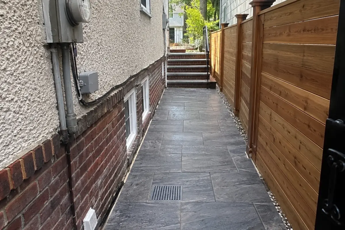 Large-format porcelain paver walkway leading to a residential townhouse entrance