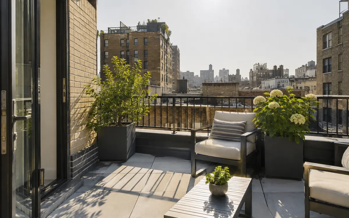 Modern outdoor terrace finished with large-format light gray porcelain pavers