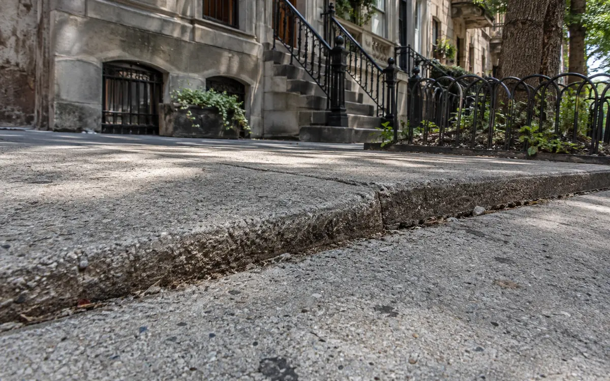 Raised and uneven concrete sidewalk slabs requiring NYC DOT sidewalk violation repair