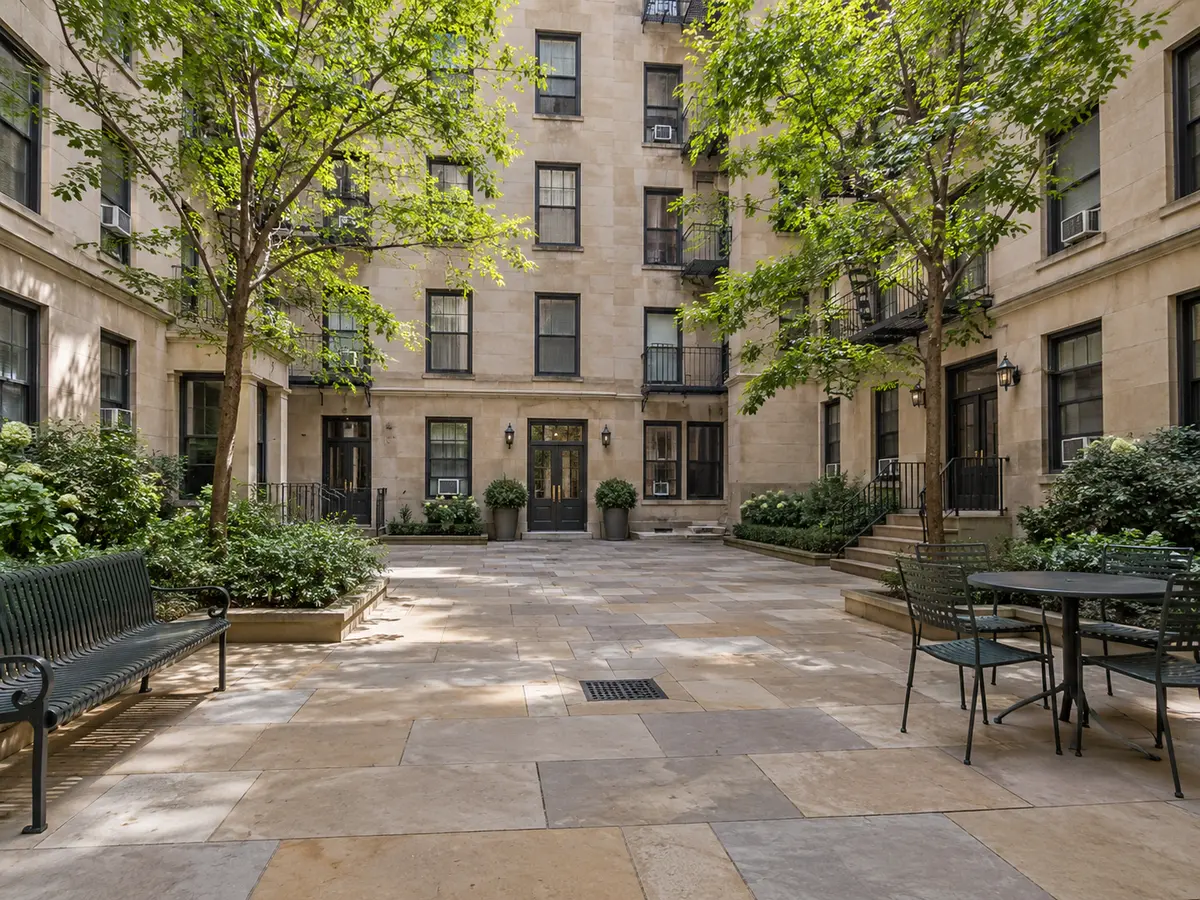 Sandstone courtyard patio behind an NYC row house
