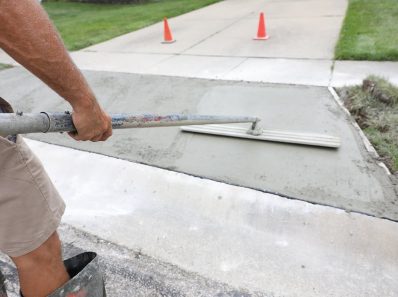 concrete work is being performed at a home in a urban neighborho